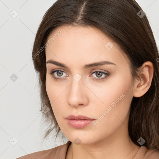 Neutral white young-adult female with long  brown hair and brown eyes