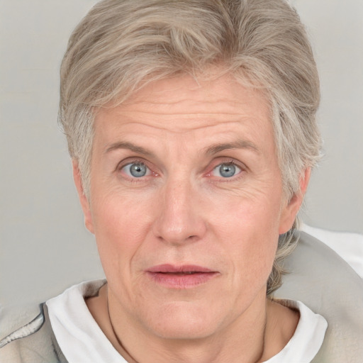 Joyful white adult female with short  blond hair and blue eyes