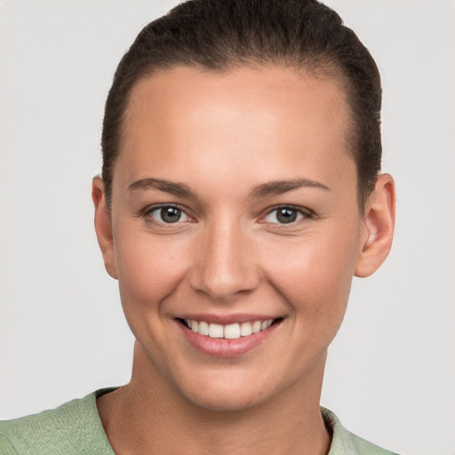 Joyful white young-adult female with short  brown hair and brown eyes