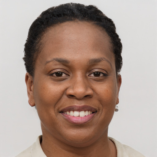 Joyful black young-adult female with short  brown hair and brown eyes