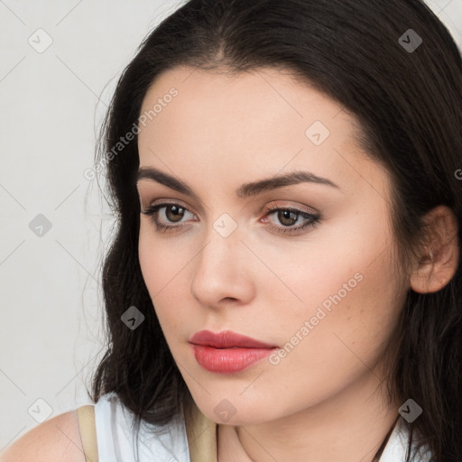 Neutral white young-adult female with long  brown hair and brown eyes