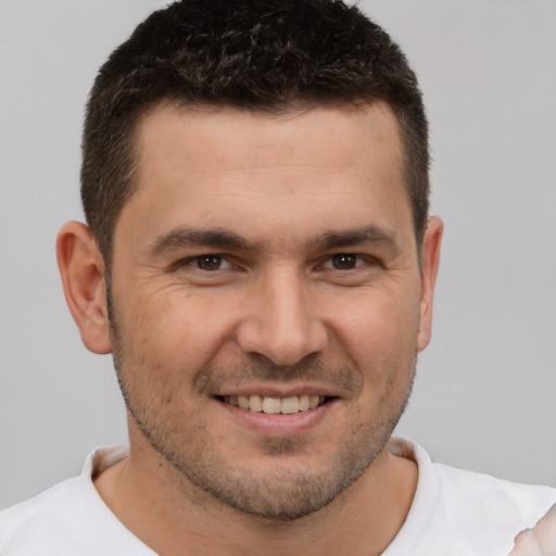 Joyful white young-adult male with short  brown hair and brown eyes