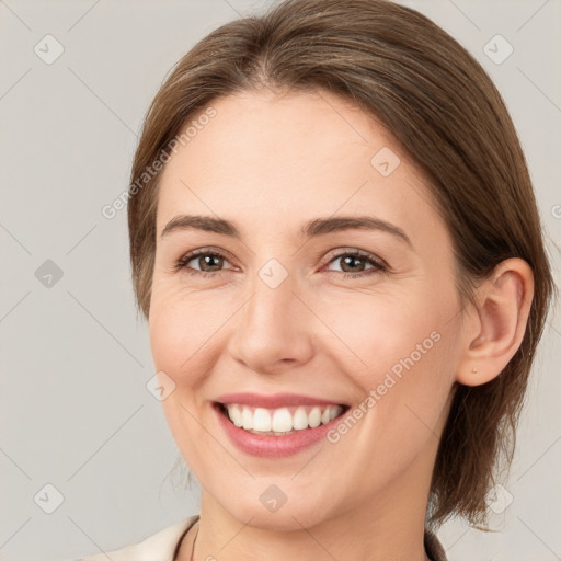 Joyful white young-adult female with medium  brown hair and grey eyes