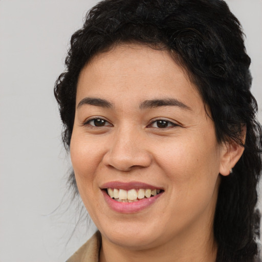 Joyful latino young-adult female with medium  brown hair and brown eyes
