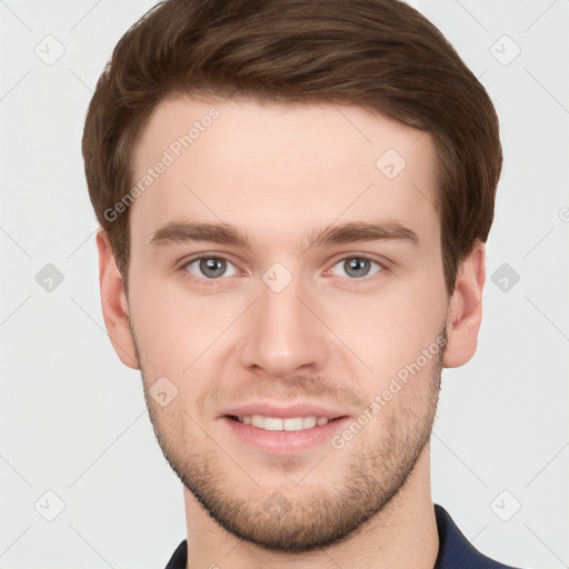 Joyful white young-adult male with short  brown hair and grey eyes