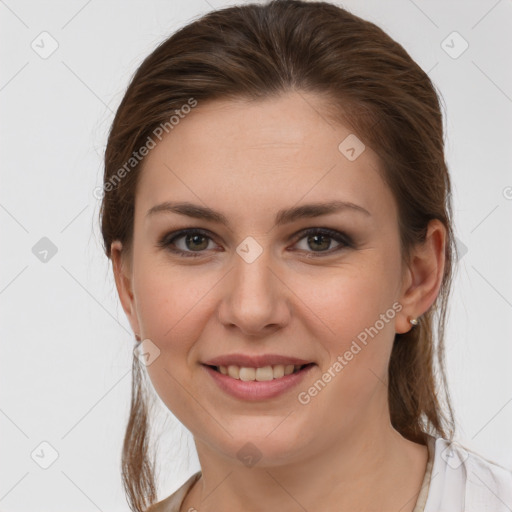 Joyful white young-adult female with medium  brown hair and grey eyes