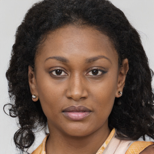 Neutral black young-adult female with long  brown hair and brown eyes