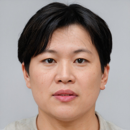 Neutral asian adult female with short  brown hair and brown eyes