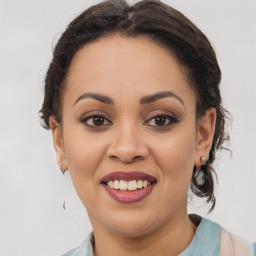 Joyful latino young-adult female with medium  brown hair and brown eyes