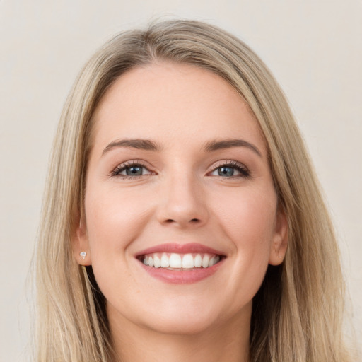 Joyful white young-adult female with long  brown hair and grey eyes