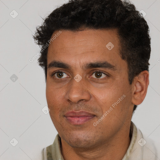 Joyful white adult male with short  black hair and brown eyes