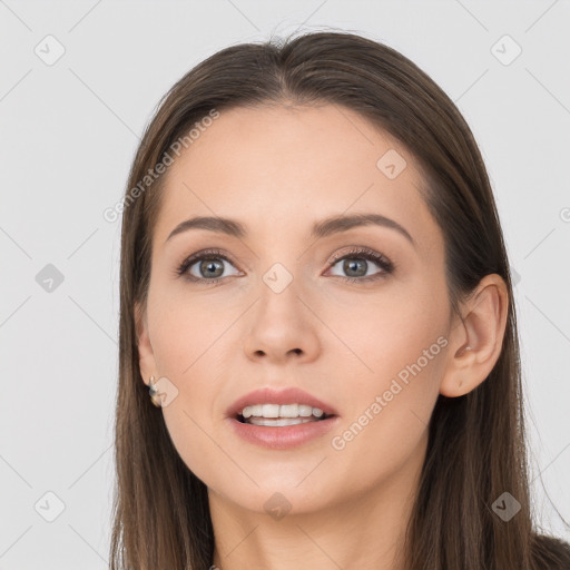 Joyful white young-adult female with long  brown hair and grey eyes