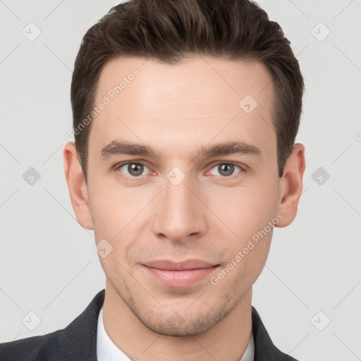 Joyful white young-adult male with short  brown hair and grey eyes