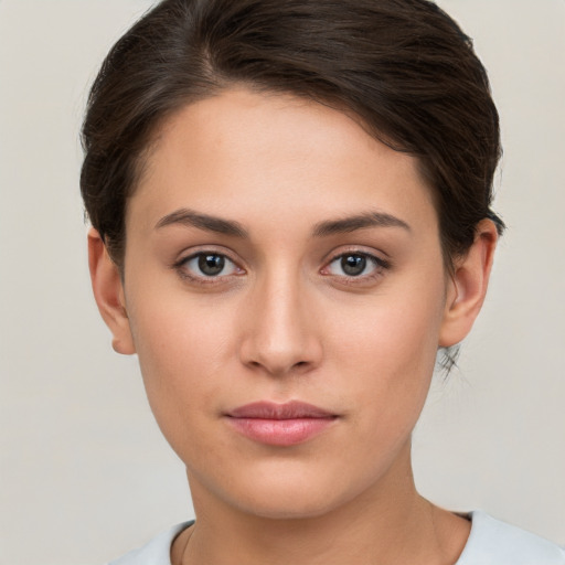 Joyful white young-adult female with short  brown hair and brown eyes