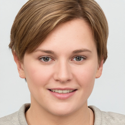 Joyful white young-adult female with short  brown hair and grey eyes