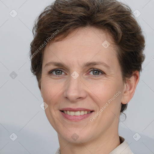 Joyful white adult female with short  brown hair and grey eyes