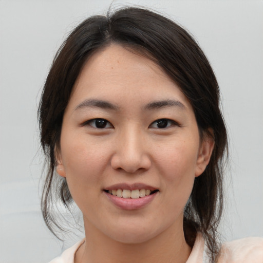 Joyful asian young-adult female with medium  brown hair and brown eyes