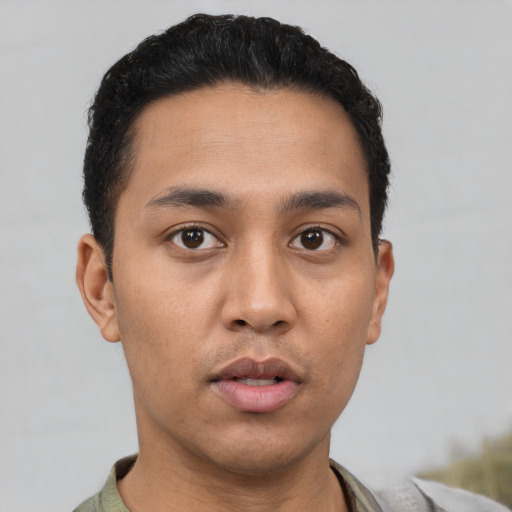 Neutral latino young-adult male with short  black hair and brown eyes