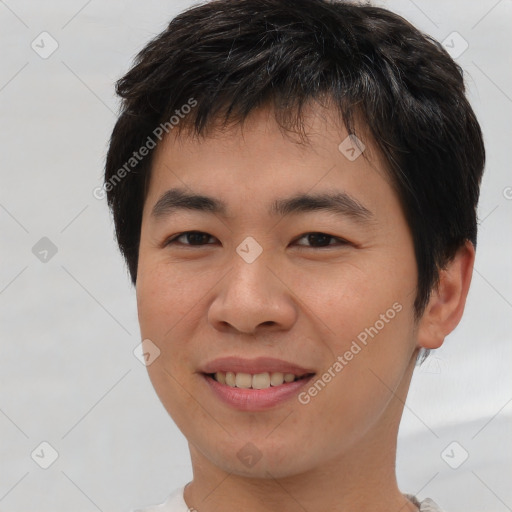 Joyful asian young-adult male with short  brown hair and brown eyes