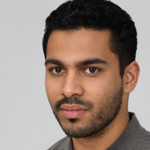 Neutral latino young-adult male with short  black hair and brown eyes