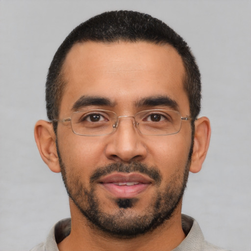 Joyful latino young-adult male with short  black hair and brown eyes