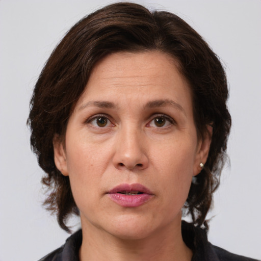 Joyful white adult female with medium  brown hair and grey eyes