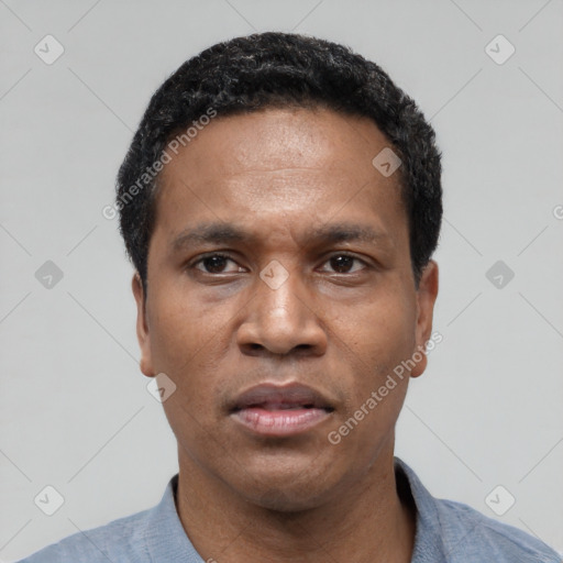 Neutral latino adult male with short  black hair and brown eyes