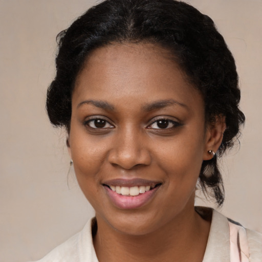 Joyful black young-adult female with medium  brown hair and brown eyes