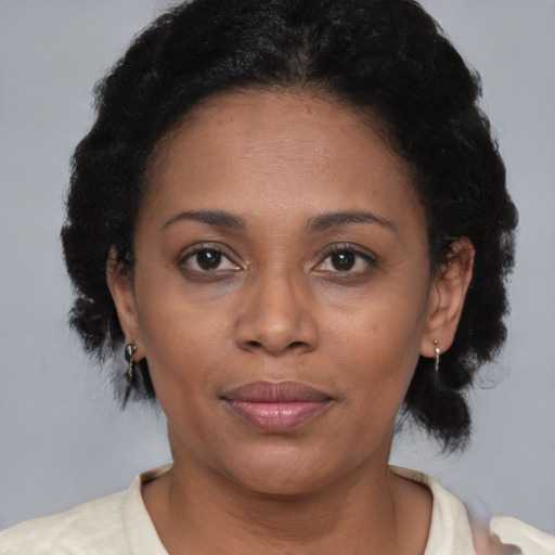 Joyful black adult female with short  brown hair and brown eyes