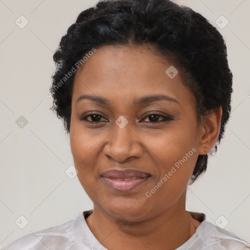 Joyful black adult female with short  black hair and brown eyes