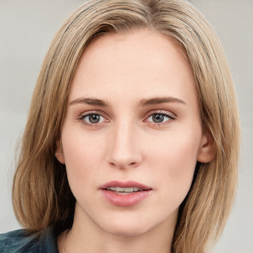 Joyful white young-adult female with medium  brown hair and blue eyes