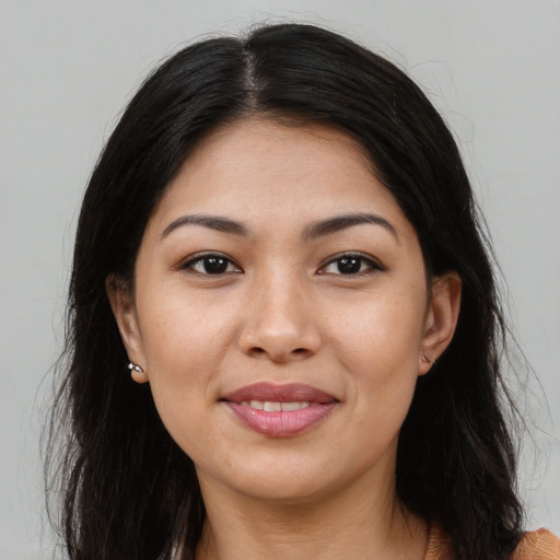 Joyful asian young-adult female with long  brown hair and brown eyes