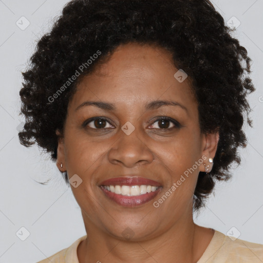 Joyful black adult female with short  brown hair and brown eyes