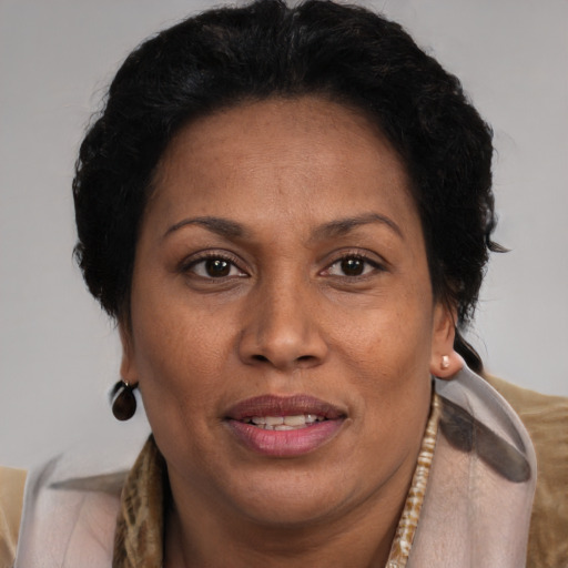 Joyful black adult female with short  brown hair and brown eyes