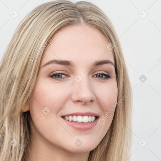 Joyful white young-adult female with long  brown hair and green eyes