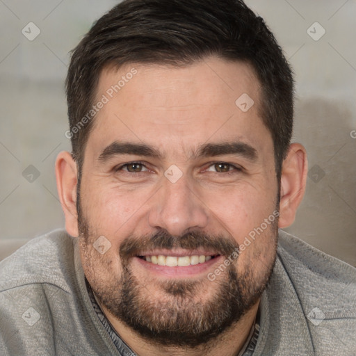 Joyful white adult male with short  brown hair and brown eyes