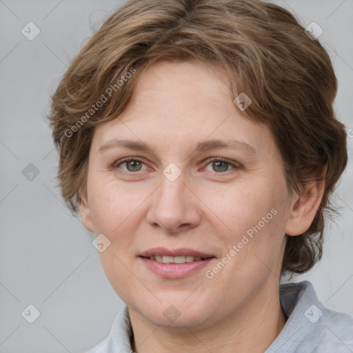 Joyful white adult female with medium  brown hair and blue eyes