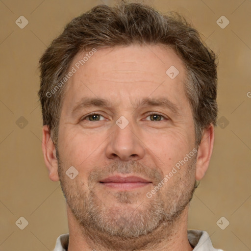 Joyful white adult male with short  brown hair and brown eyes