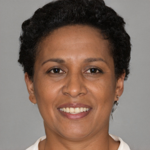 Joyful latino adult female with short  brown hair and brown eyes