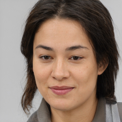 Joyful white young-adult female with medium  brown hair and brown eyes