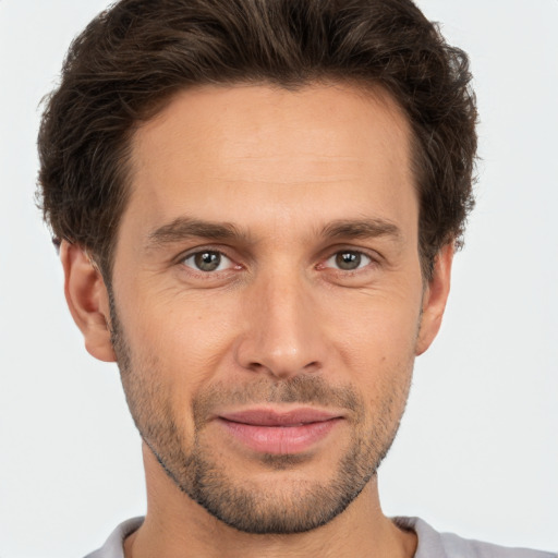 Joyful white adult male with short  brown hair and brown eyes