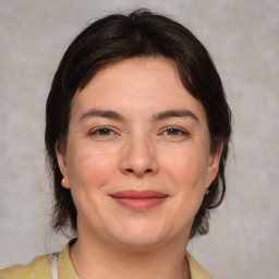 Joyful white adult female with medium  brown hair and brown eyes