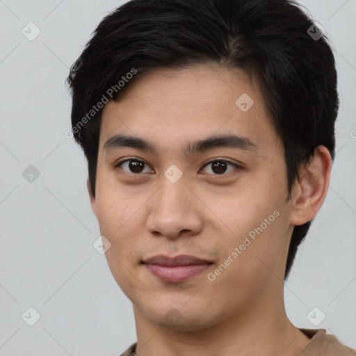 Joyful asian young-adult male with short  brown hair and brown eyes