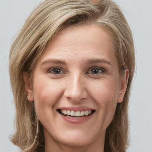 Joyful white young-adult female with long  brown hair and blue eyes