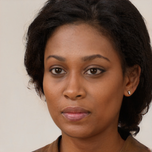 Neutral black young-adult female with long  brown hair and brown eyes