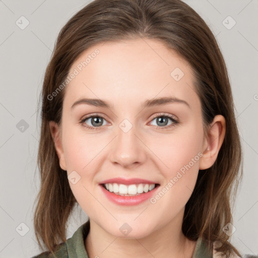 Joyful white young-adult female with medium  brown hair and grey eyes