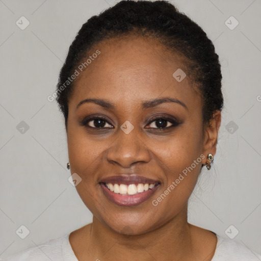 Joyful black young-adult female with short  black hair and brown eyes