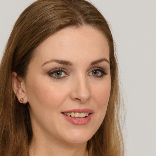 Joyful white young-adult female with long  brown hair and green eyes