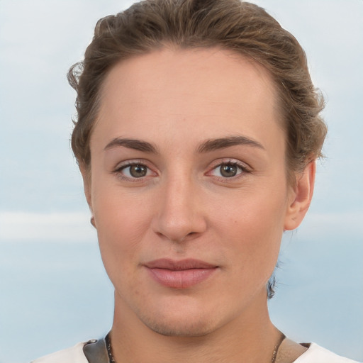 Joyful white young-adult female with short  brown hair and grey eyes