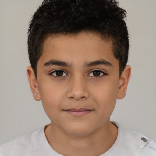 Joyful latino child male with short  brown hair and brown eyes